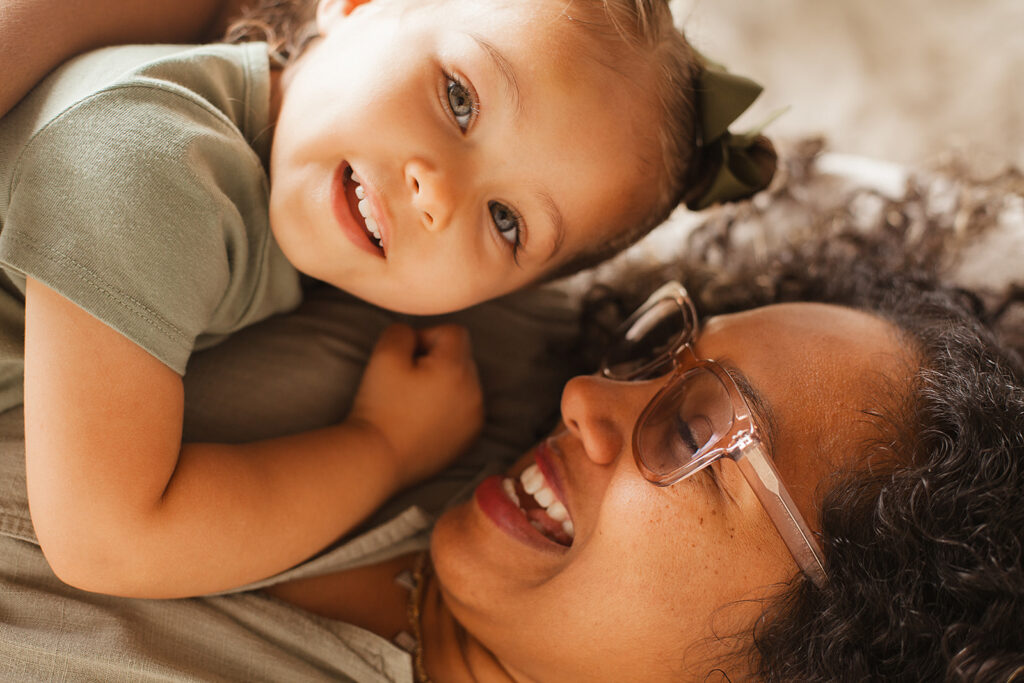 Close up portrait of mother hugging toddler and toddler looking at the camera during family session in Neutral Moon Studio, Atlanta.