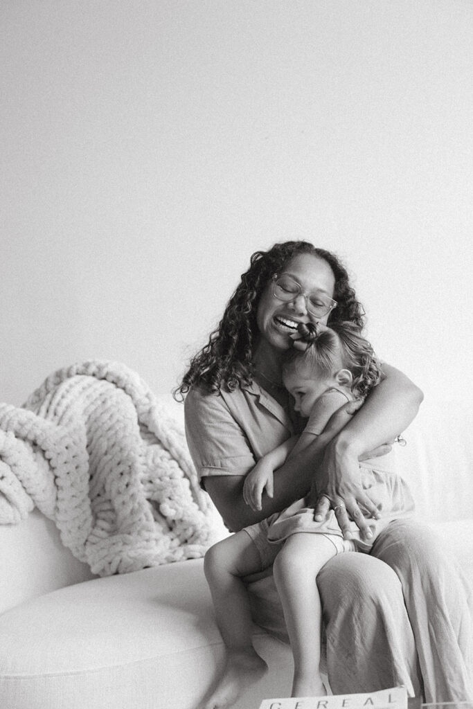 Black and white photo of mom hugging toddler during studio family photography session in Atlanta, GA.
