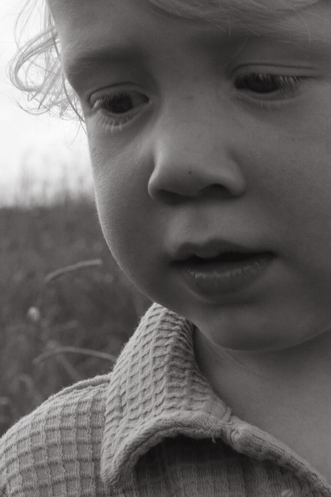 Black and white portrait of toddler looking down during family session in Atlanta, GA